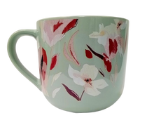 Load image into Gallery viewer, A green ceramic mug with a floral pattern of pink and white flowers and leaves.
